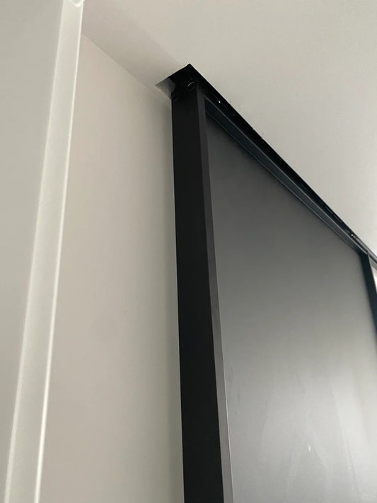 White Rothnow aluminum 16x45 series barn door with slim frame and clear glass for living room installation.