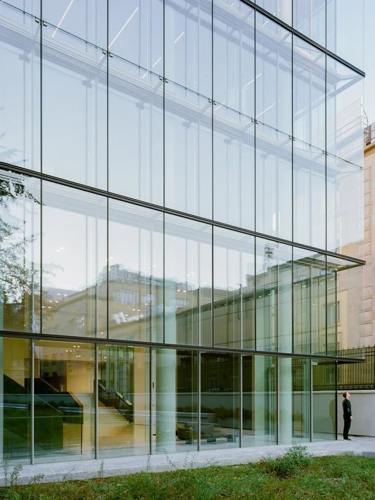 Black Rothnow glass curtain wall with exposed frame, showcasing sleek, modern architectural window design.