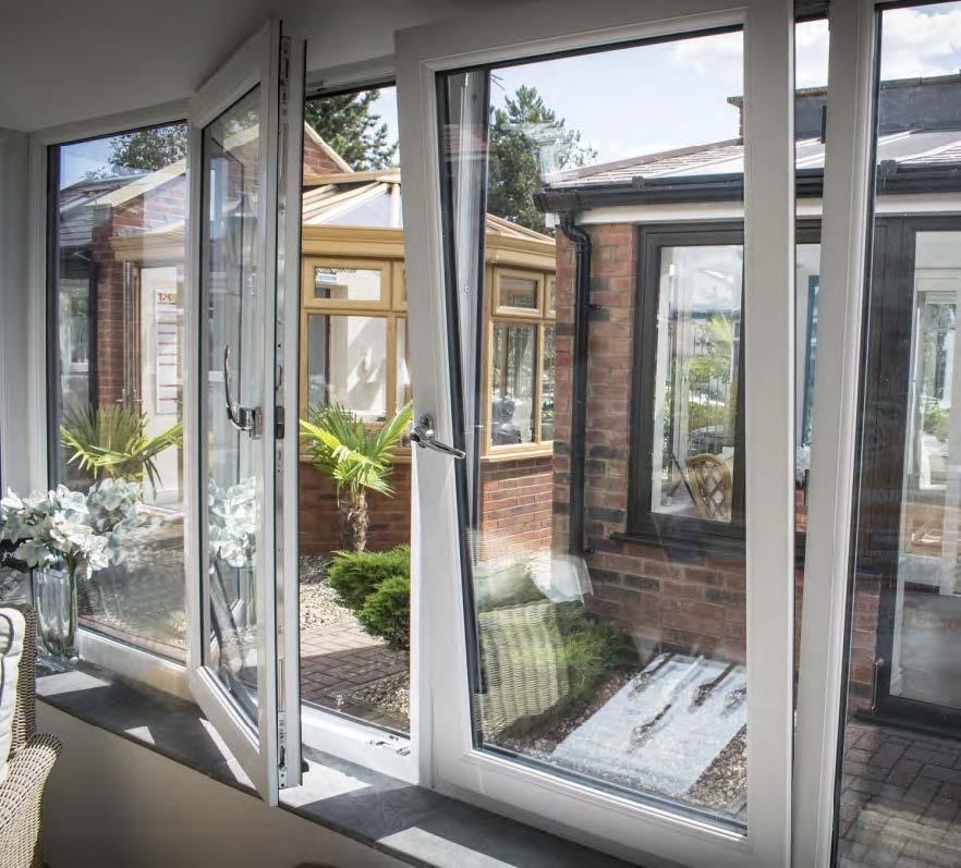 Rothnow UPVC vinyl tilt and turn window, black frame, 24x36 inches, with open tilt and turn sash, installed in a modern setting.