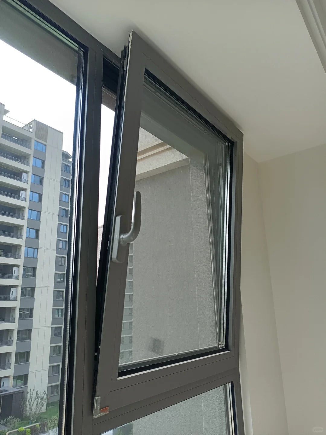 Rothnow UPVC Vinyl Tilt and Turn Window in black, measuring 24x36 inches, with open tilt and turn hardware visible.