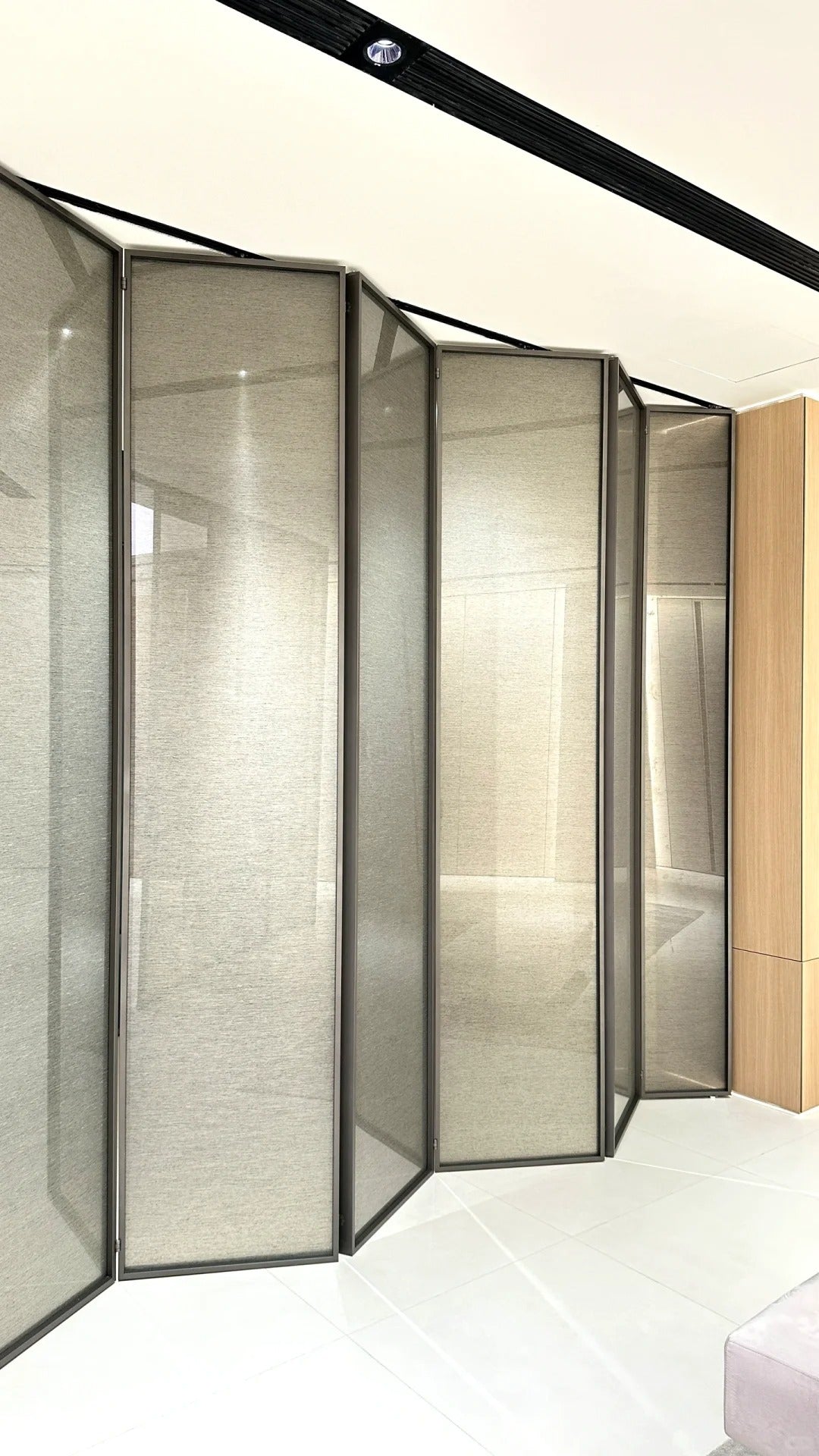 Rothnow aluminum bi-fold door with slim white frame and clear glass panels, 16x45 series folding door in a modern interior setting
