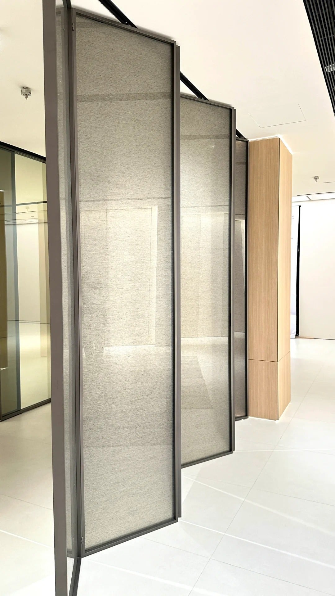 Rothnow® aluminum 16x45 series slim frame bi-fold door with clear glass, white finish, folded open to showcase modern design.