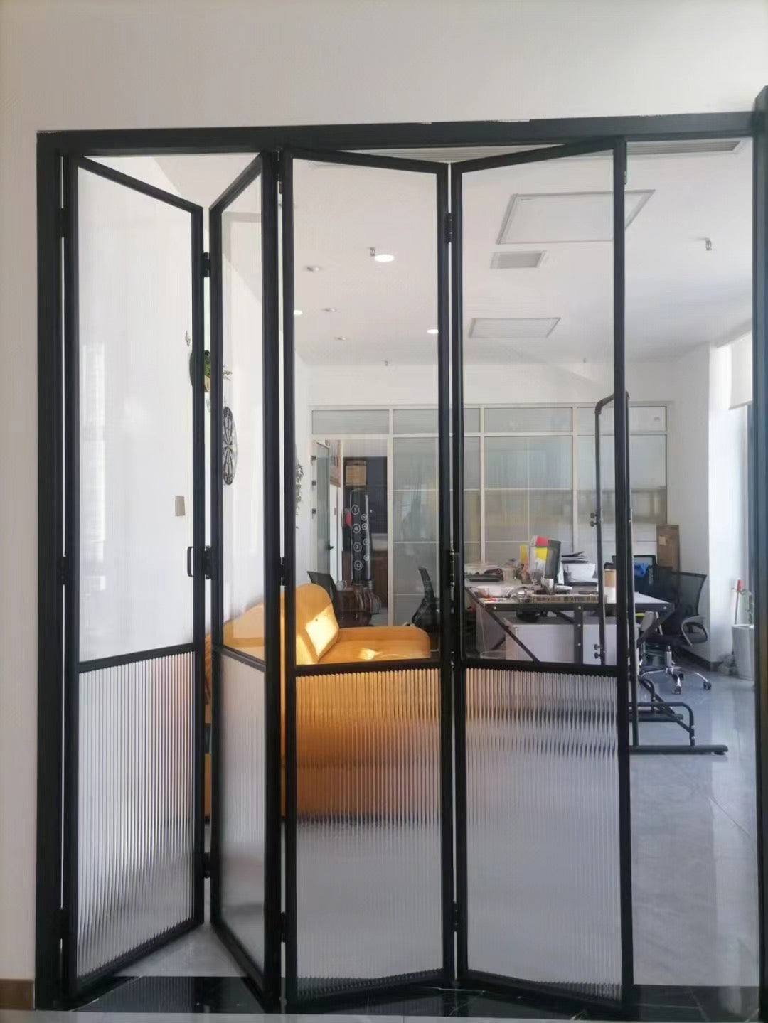 Rothnow aluminum 16x45 series slim frame bi-fold door with waved glass and white finish, showing the sleek folding door design.