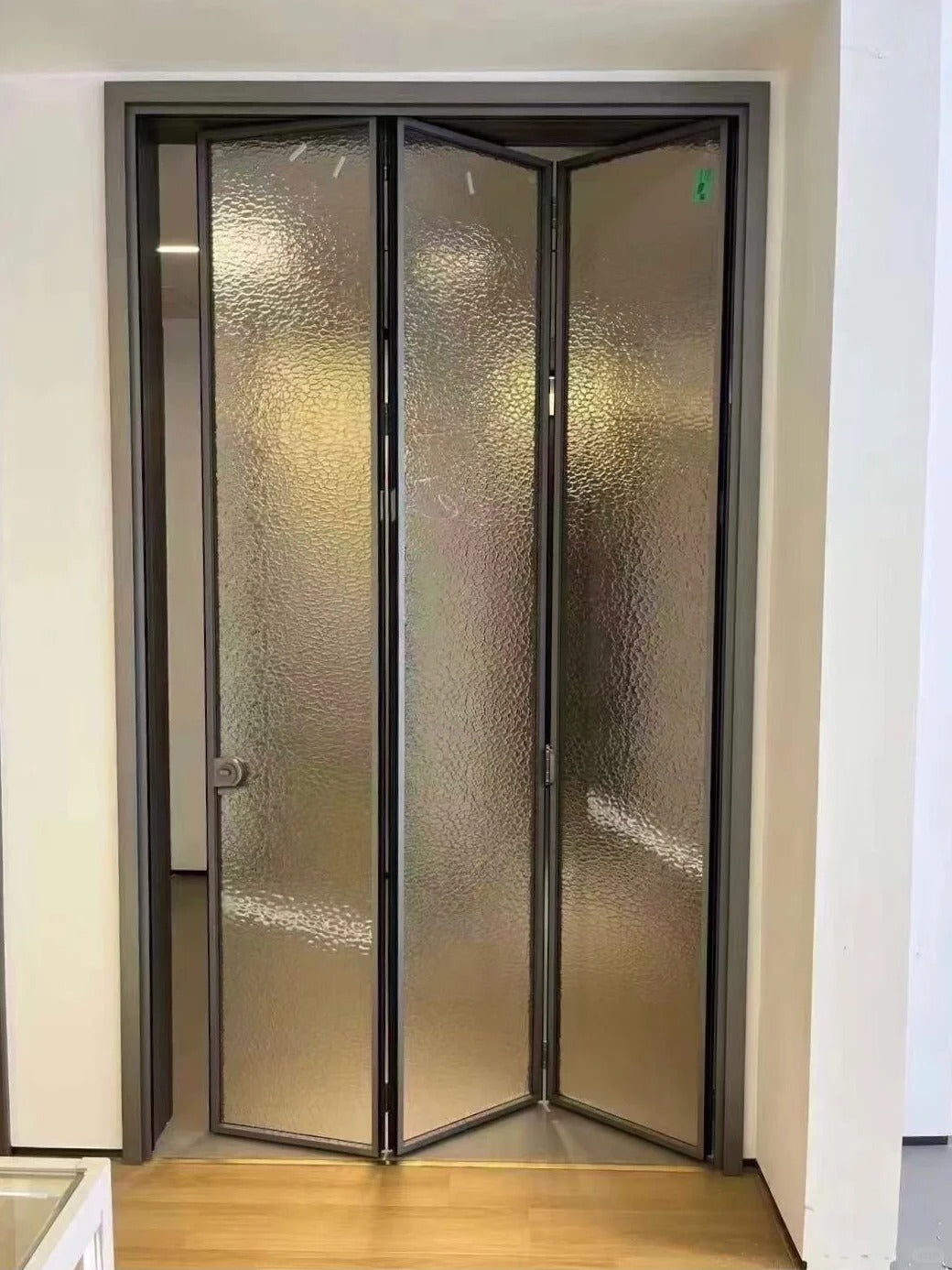 Rothnow aluminum 18x35 series slim frame bi-fold door with clear privacy glass, white finish, for modern interior or exterior use.