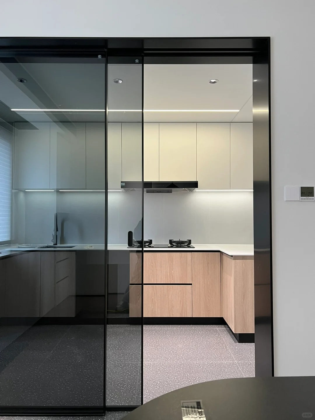 Rothnow® 7x45 Series aluminum black sliding door with clear glass, slim frame, and white skin for modern home interiors