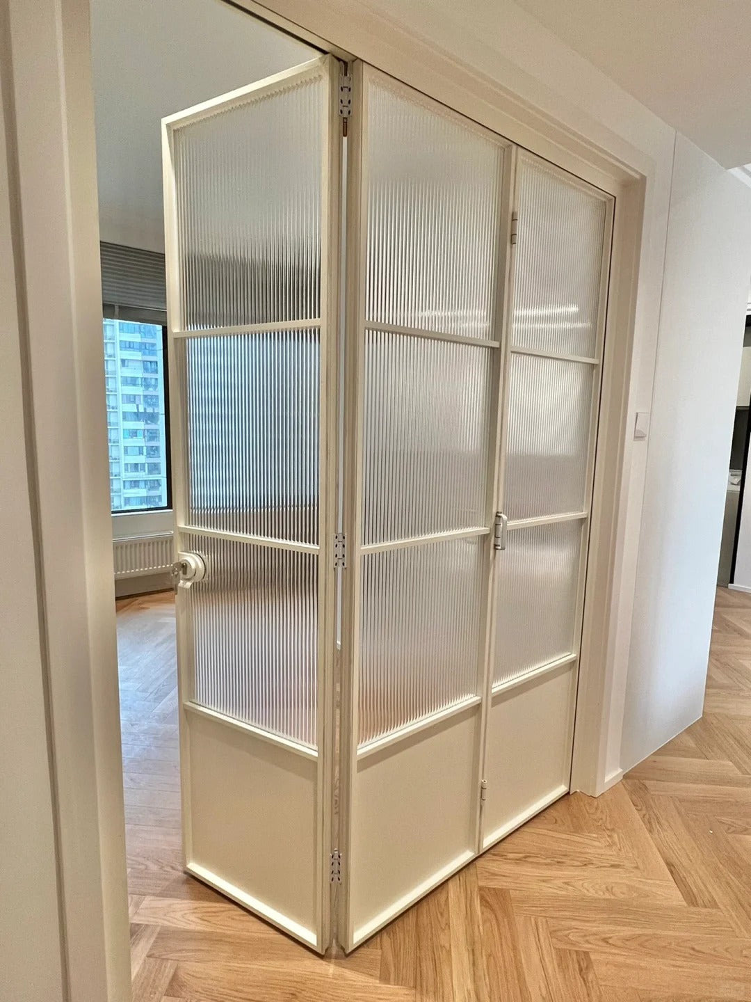Rothnow French Style Aluminum Bi-fold Door with slim white frame, clear glass panels, for living room, 18x35 series.
