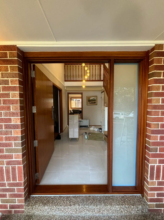 Rothnow® wood front door with stainless steel accents, 800mm wide and 2100mm tall, featuring a modern pivot design in brown finish.