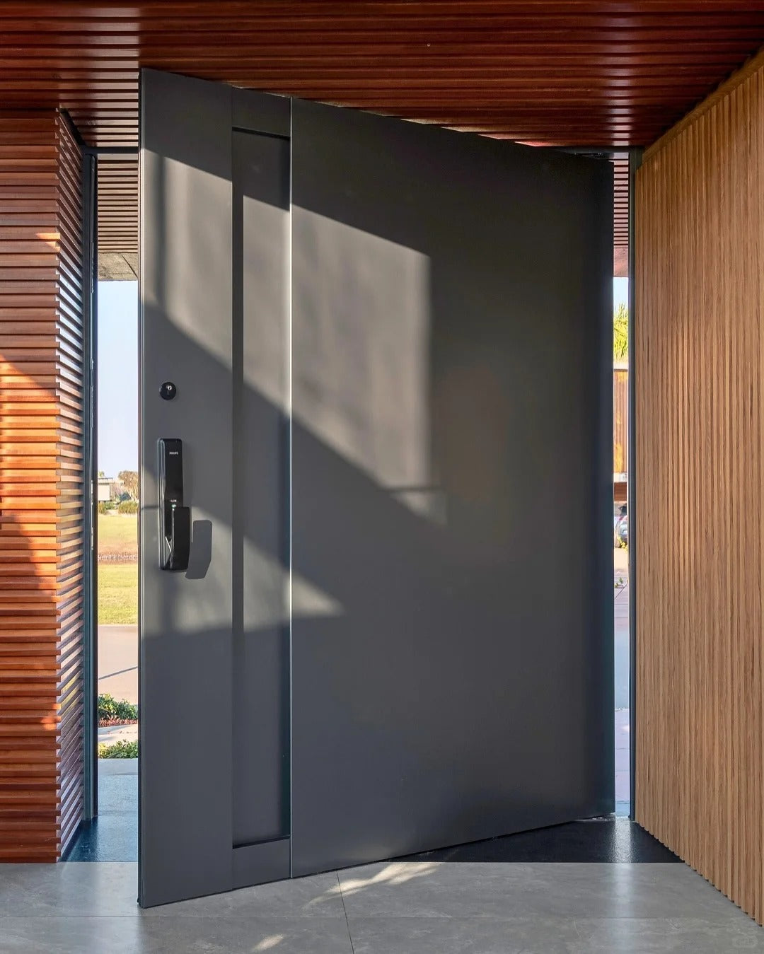 Rothnow stainless steel front door with brown finish, pivot design, 800mm width, 2100mm height, and 150mm wall thickness.