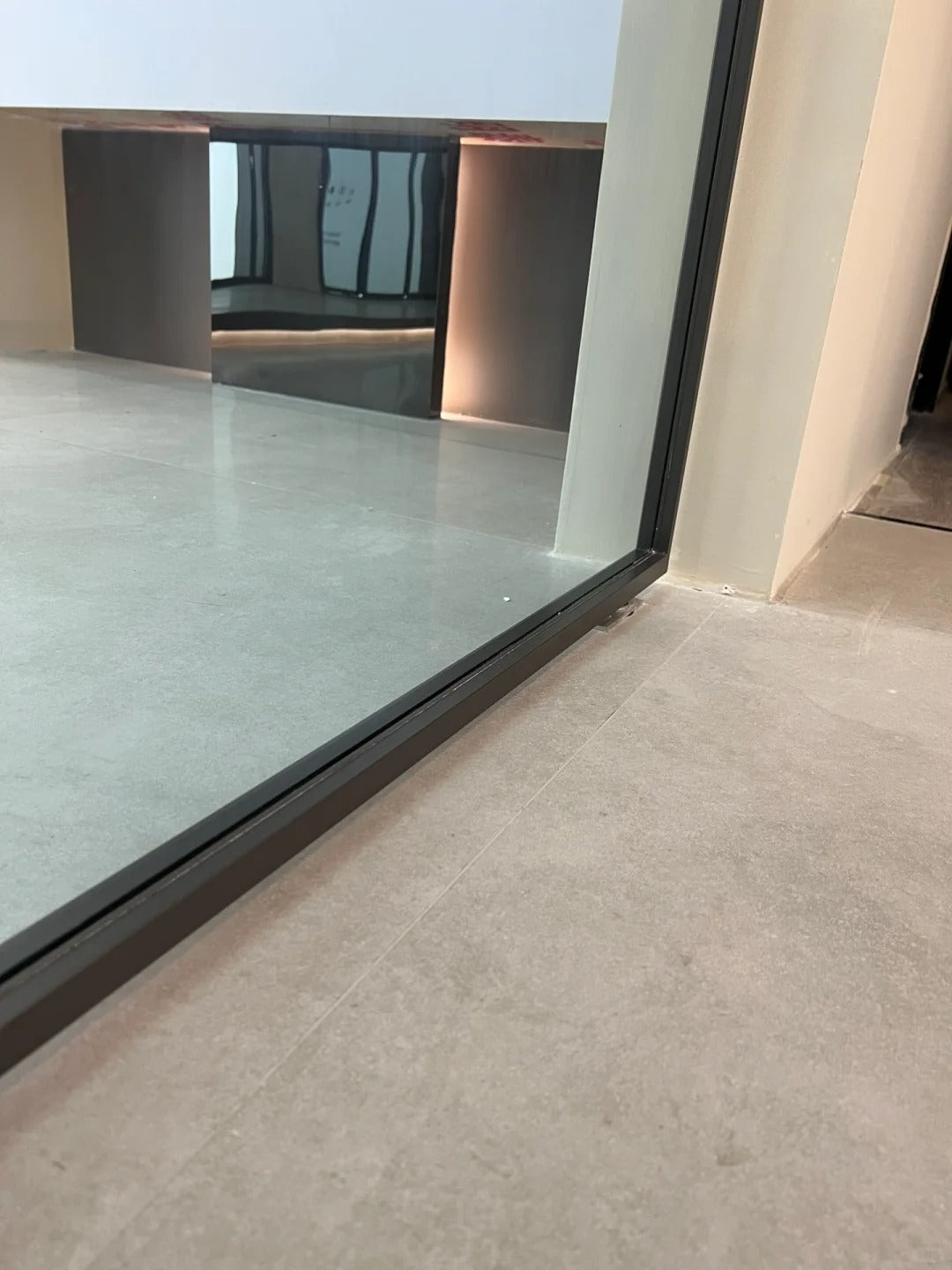 Rothnow aluminum 16x45 pivot door with European grey glass and white skin, featuring sleek modern design and clear glass panels.