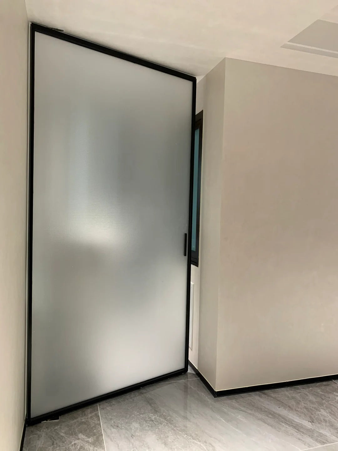 Rothnow Aluminum 16x45 Series Pivot Door with white oil sand finish and clear glass, showcasing modern design and sleek aesthetic.