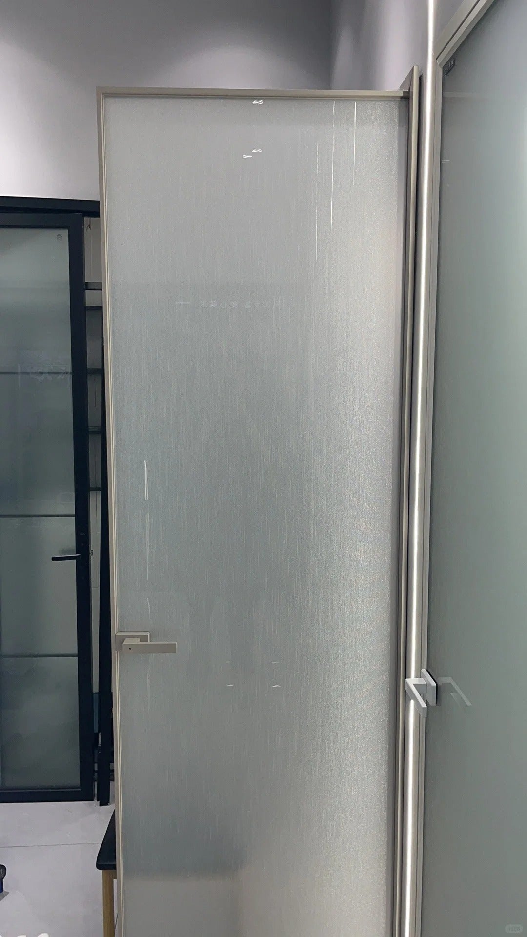 White Rothnow aluminum door with wired glass, 16x45 series, 820mm W x 2220mm H with clear glass skin.