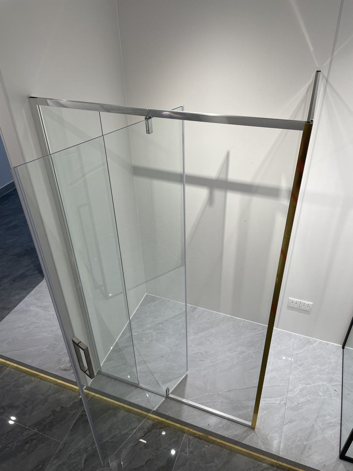 Rothnow® black profile pivot shower door on a sleek shower panel, featuring modern design and clear glass for a contemporary bathroom.