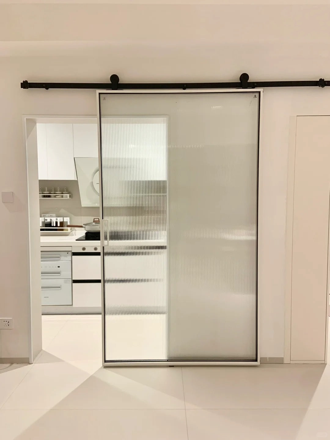 Rothnow® Aluminum Door from the 16x45 Series, American style slim frame barn door with clear glass and white finish.