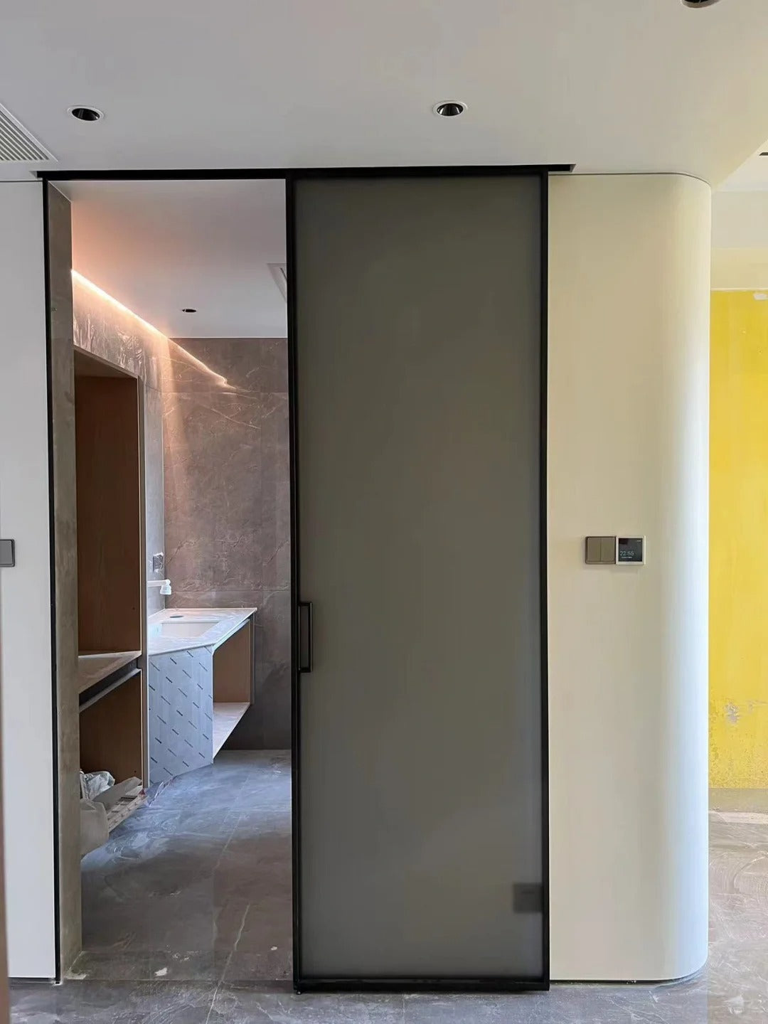 Rothnow® aluminum barn door with clear glass, slim frame, 16x45 series, used as a living room door in modern interiors.