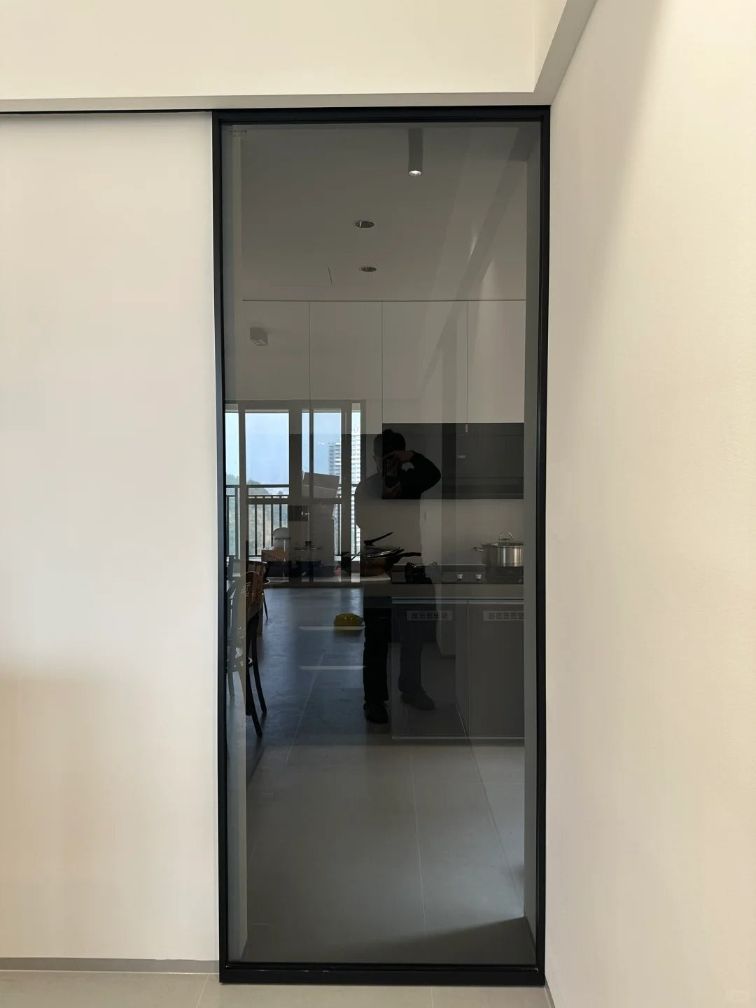 Rothnow® aluminum door with 16x45 slim frame, clear glass with crystal grey tint, modern ghost door design, white finish.