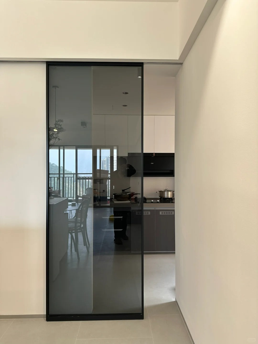 Rothnow® Aluminum Door 16x45 Series Slim Frame Ghost Door with Crystal Grey Glass, featuring a modern white aluminum frame and clear glass.