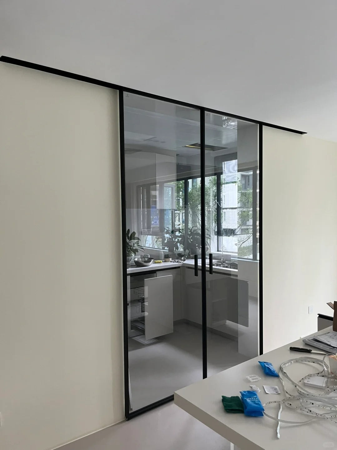 Rothnow® aluminum door with clear glass, 7x45 series super slim frame barn kitchen door, white finish on a modern interior.