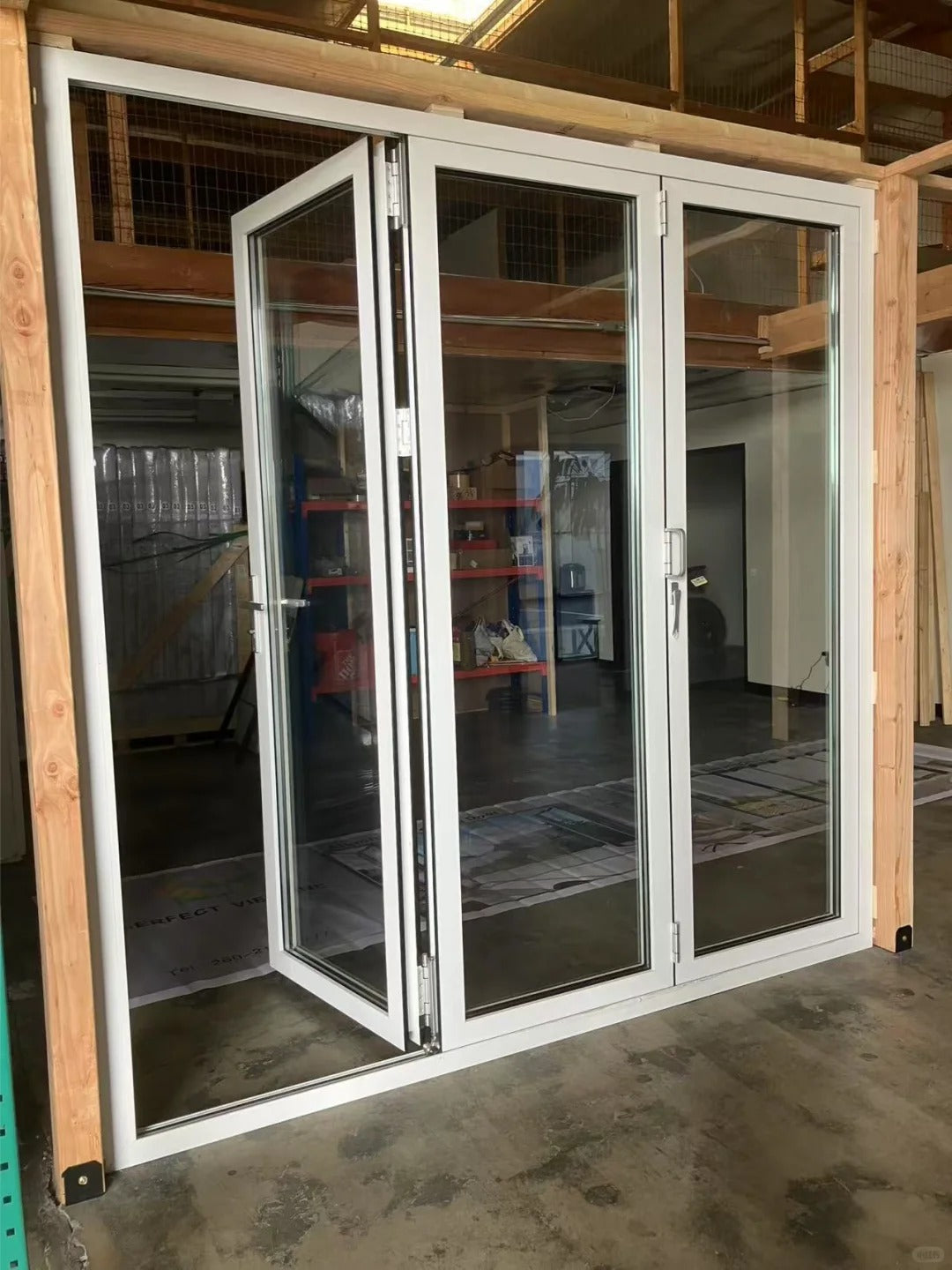 Rothnow Vinyl Folding UPVC Door 900mm wide by 2200mm high with black finish, showcasing its sleek design and folding mechanism.