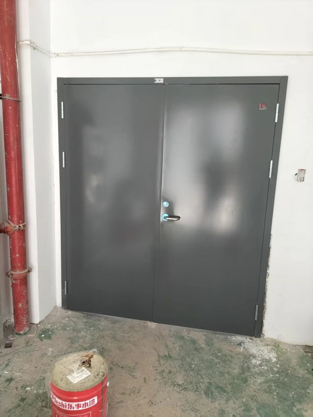 Rothnow steel fire-rated swing door with 990mm width, 2360mm height, and 150mm wall thickness, shown installed in a wall.
