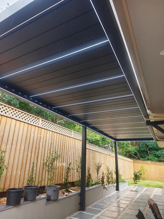 Black Rothnow aluminum climate pergola with sleek ceiling design, custom-sized for outdoor shading and style.
