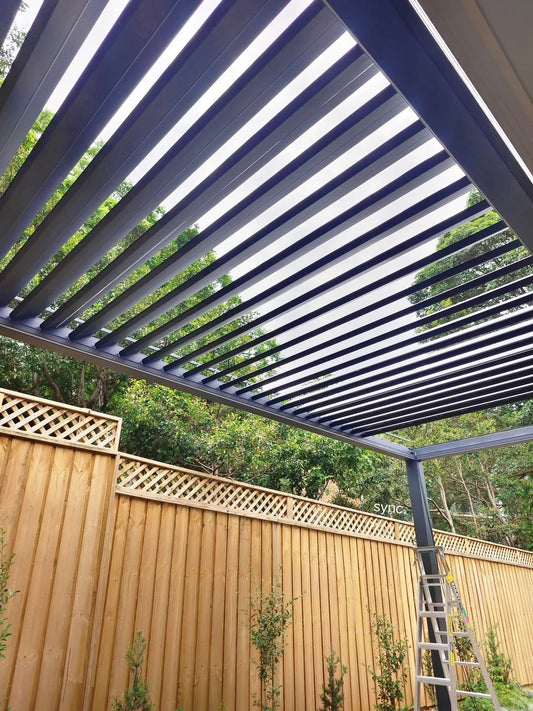 Black Rothnow aluminum pergola with adjustable climate features, showcasing a sleek, modern design for outdoor terrace or garden use.