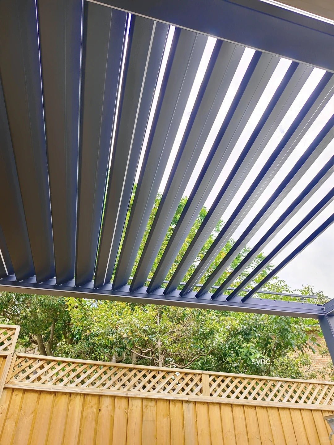 Black Rothnow aluminum pergola with custom size, sleek roof design, and durable climate-resistant aluminum alloy framing.