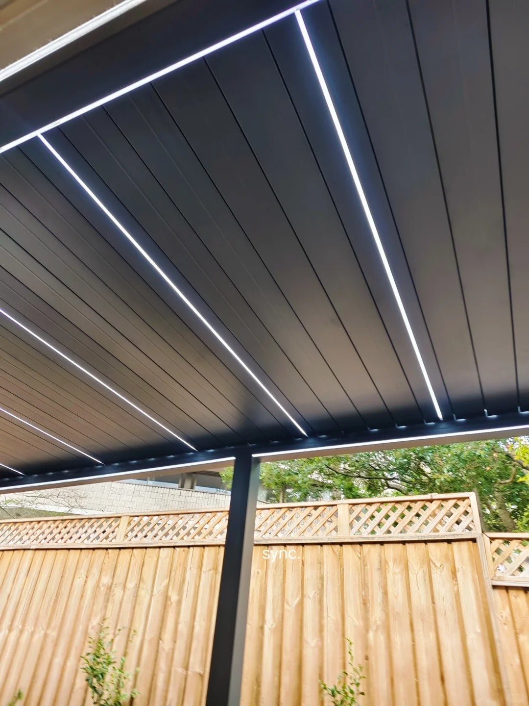 Black Rothnow aluminum pergola with customizable size, featuring sleek design and durable alloy climate-resistant construction.