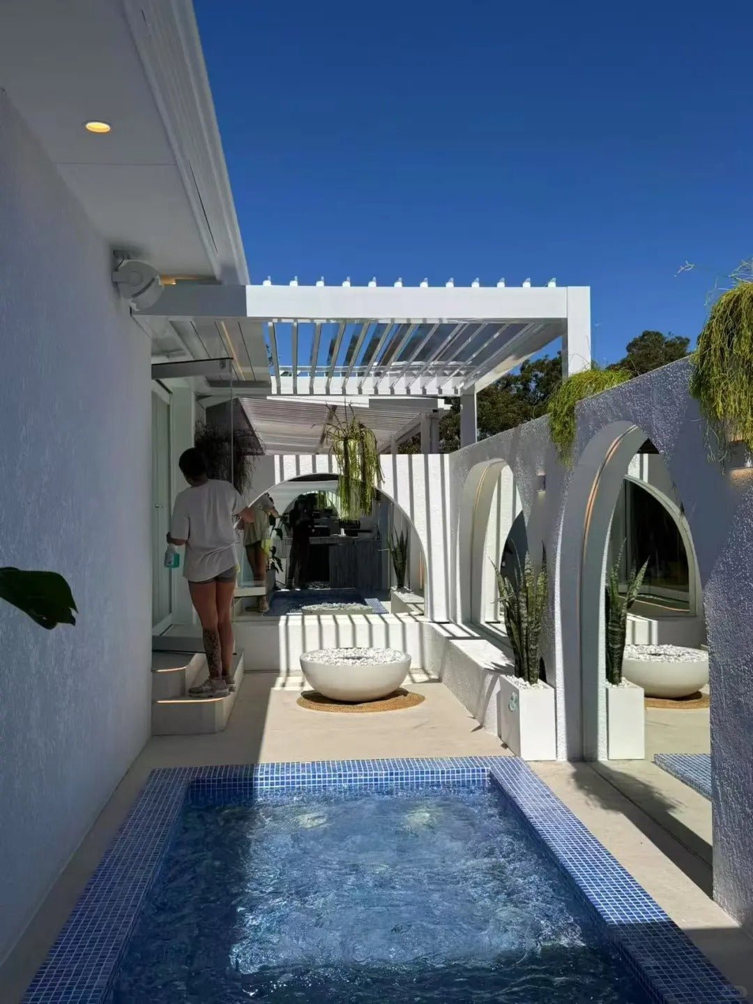 Black Rothnow aluminum pergola with durable alloy frame, designed for climate control and outdoor shade.