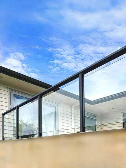 Black Rothnow® aluminum glass railing with sleek, customizable design, featuring clear glass panels and modern metal framework.