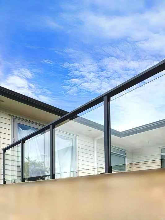 Black Rothnow® aluminum glass railing with sleek, customizable design, featuring clear glass panels and modern metal framework.