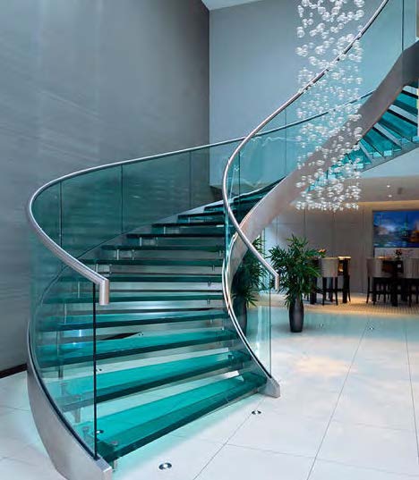 Rothnow® curved staircase with black metal frame and glass railings, showcasing a sleek and modern design for interior staircases.