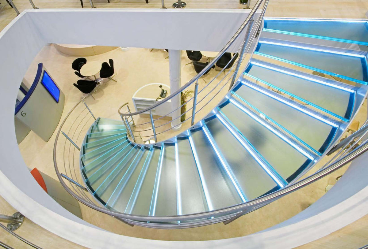 Rothnow Curved Staircase RNCS03 with black finish and glass railing, showcasing elegant curved design and modern staircase structure.