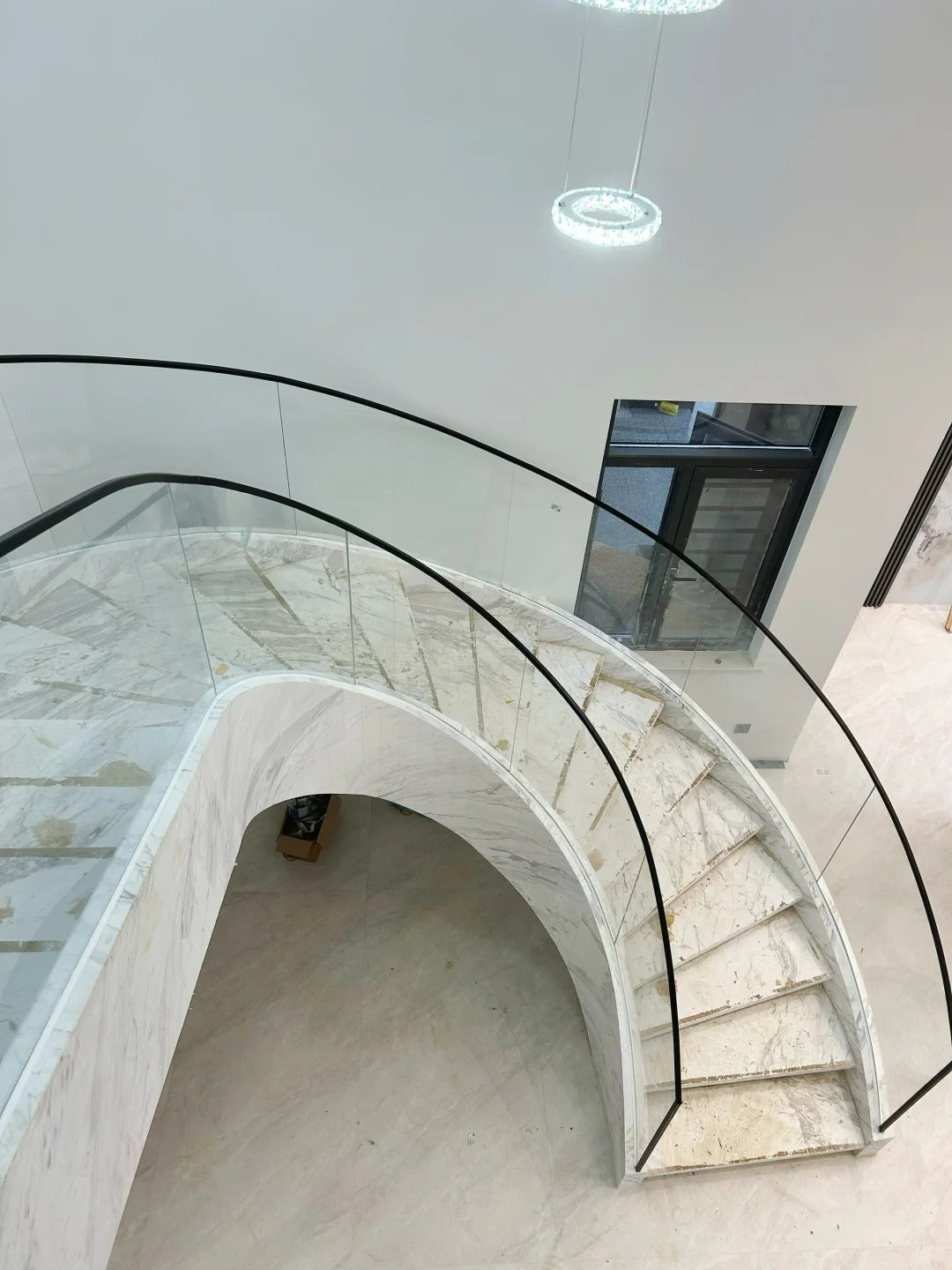 Rothnow® curved staircase in black with stone finish, custom-sized, featuring elegant design and sturdy construction.