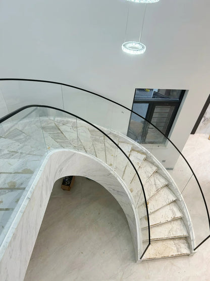 Rothnow® curved staircase in black with stone finish, custom-sized, featuring elegant design and sturdy construction.