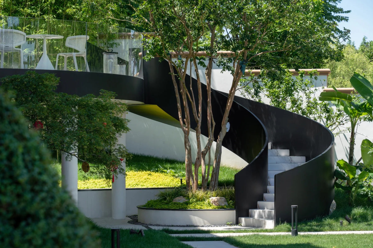 Black Rothnow curved outdoor staircase with sturdy railing and steps, designed for stylish exterior access.