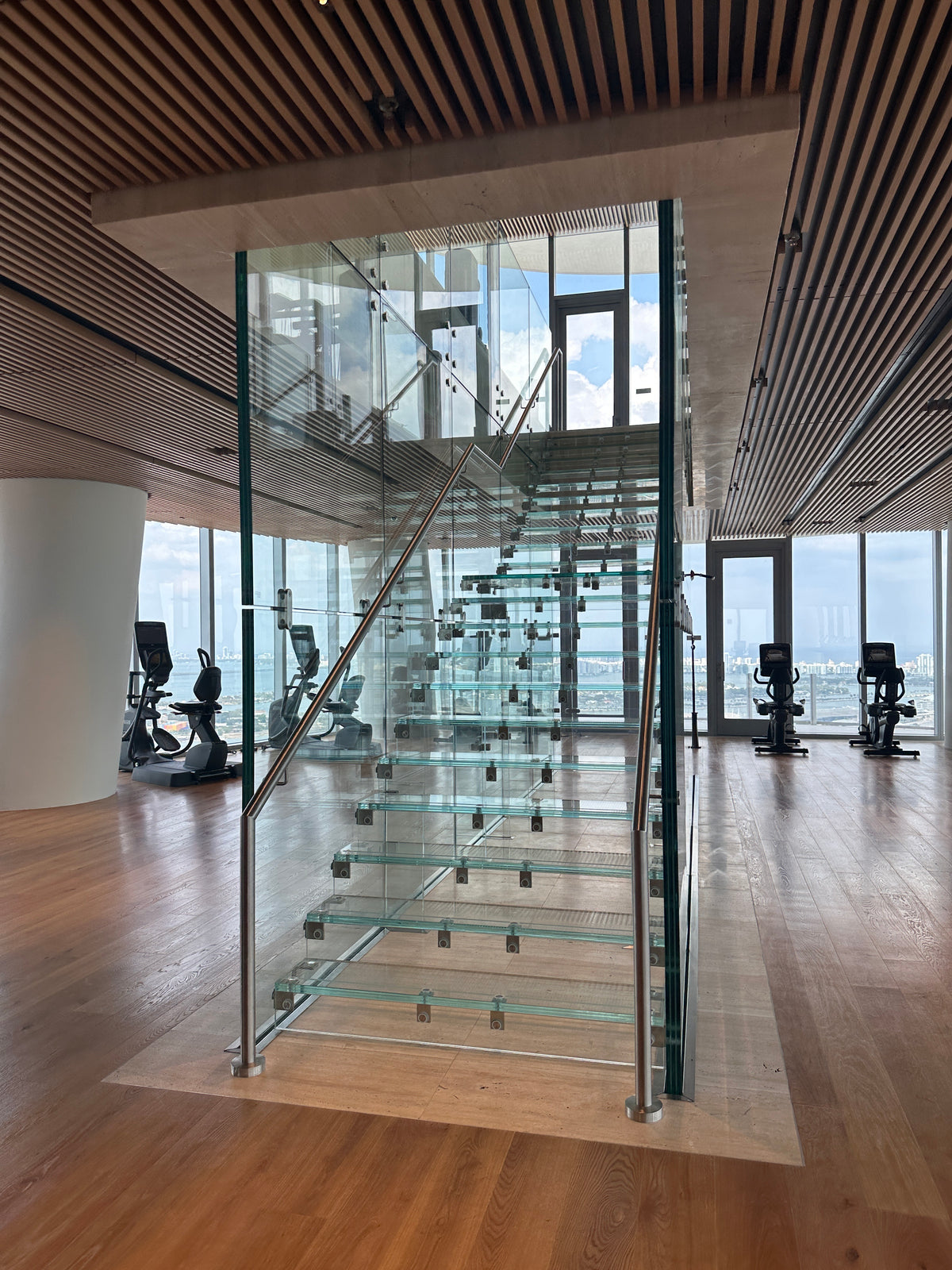 Rothnow® Glass Floating Staircase RNFS03 with black finish, showcasing sleek, modern design with transparent steps and minimalist style.