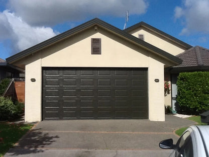 Black Rothnow® steel garage door with color finish, filled with PU foam for insulation and durability, custom-sized for installation.