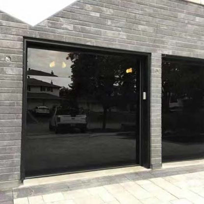 Black Rothnow full mirror glass garage door with sleek design and modern appearance, installed on a residential garage exterior.