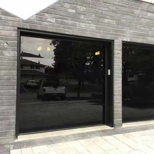 Black Rothnow full mirror glass garage door with sleek design and modern appearance, installed on a residential garage exterior.