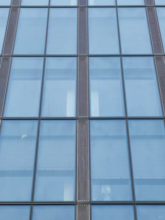 Black Rothnow glass curtain wall with exposed frame, showcasing sleek, modern architectural window design.