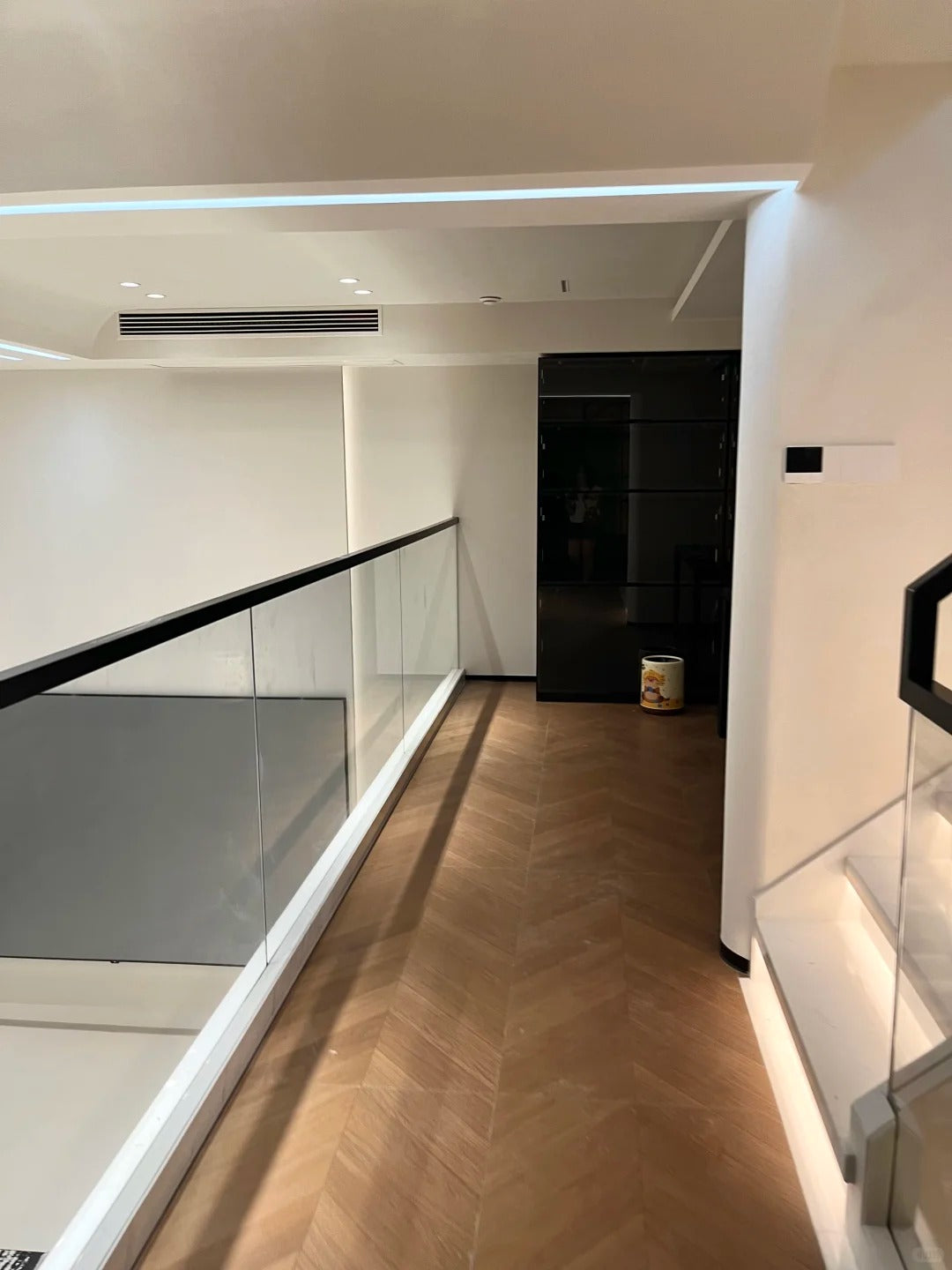 Black Rothnow Glass Railing RNGR01 U-channel safety railing with sleek glass panels, designed for modern balcony or deck installation.