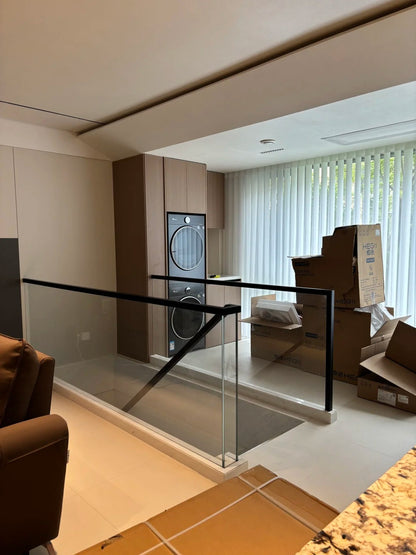 Rothnow Glass Railing RNGR01 U-channel black custom-sized safety guard for balcony or staircase, featuring clear glass panels.