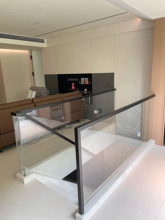 Black Rothnow Glass Railing RNGR01 U-channel railing with clear glass panels, designed for safety and modern outdoor or indoor spaces.