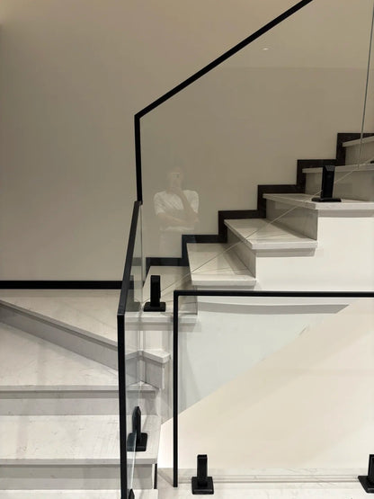 Rothnow® Glass Railing RNGR04 with black spigot, custom-sized safety railing for modern balcony or patio installation.