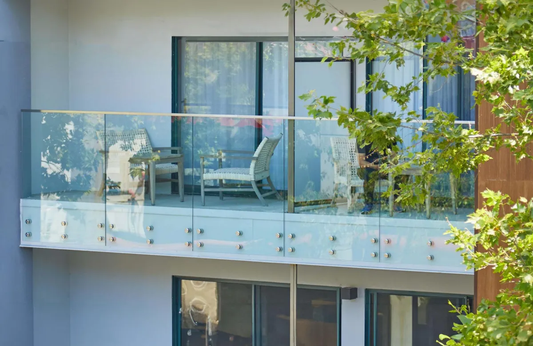 Rothnow glass railing RNGR06 standoff design with black finish, featuring clear safety glass panels and sturdy metal fittings.