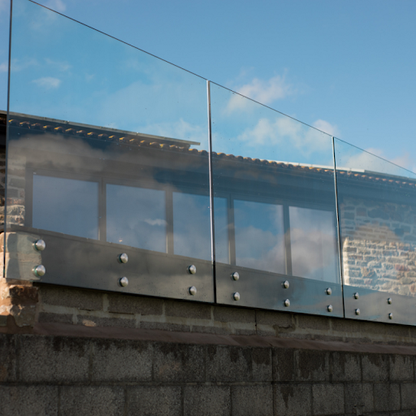 Rothnow® glass railing with black standoff design, showcasing sleek, modern glass panels for safety and style.