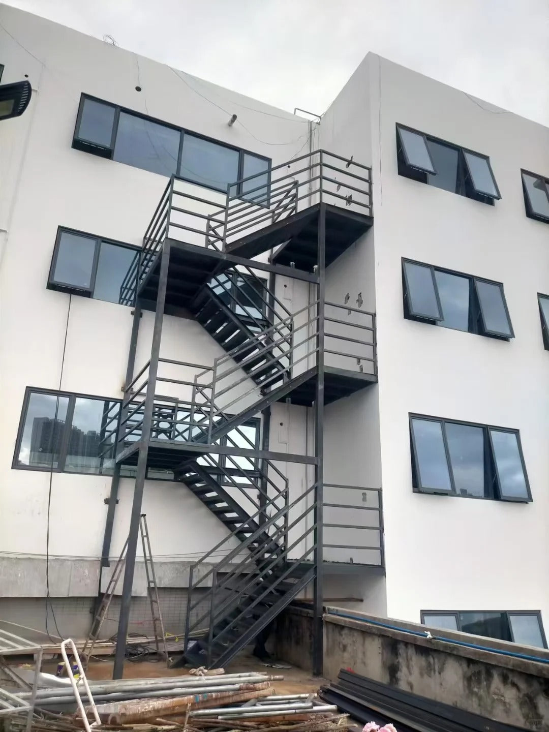 Black Rothnow outdoor staircase with sturdy metal steps and handrails, designed for fire escape and exterior building access.