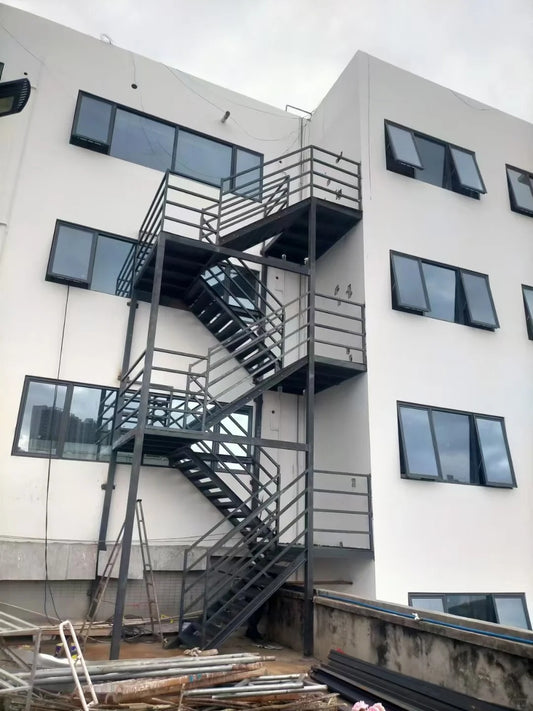 Black Rothnow outdoor staircase with sturdy metal steps and handrails, designed for fire escape and exterior building access.