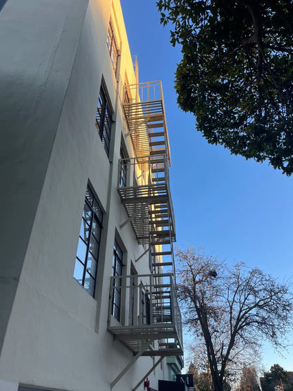 Black Rothnow outdoor fire escape staircase with sturdy metal steps and safety railings, designed for building exterior access.