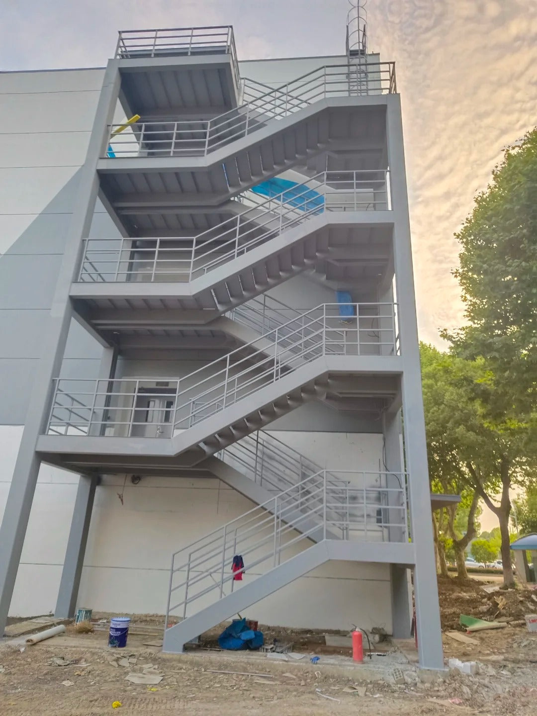 Black Rothnow outdoor staircase with sturdy metal steps and handrails, designed as a fire escape staircase.